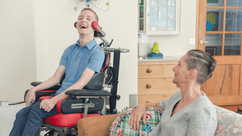 A client with cerebral palsy at home with his carer